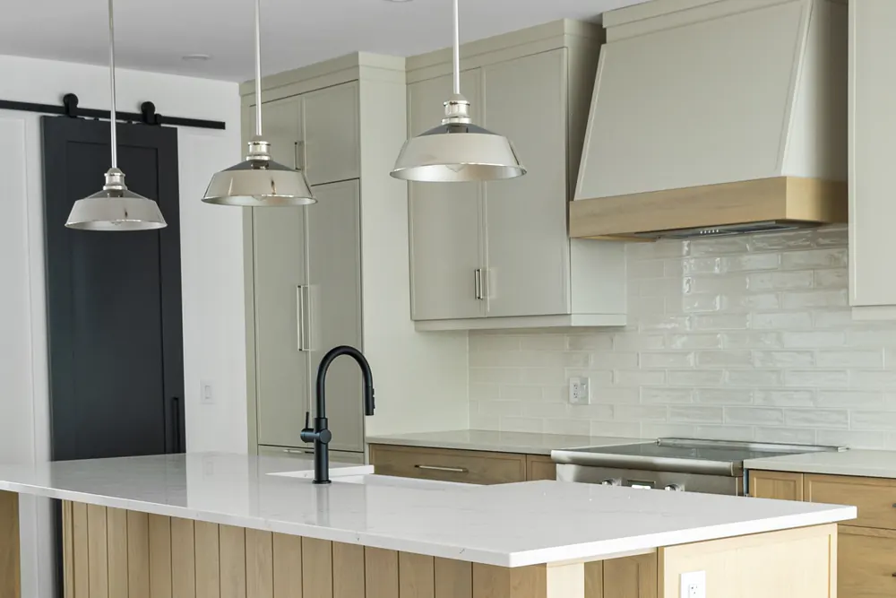 Kitchen at Dwight Beach Road with a white oak island and sage cabinetry