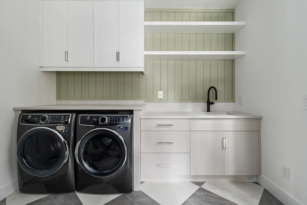 Laundry room at Dwight Beach Road with sage shiplap and open shelving