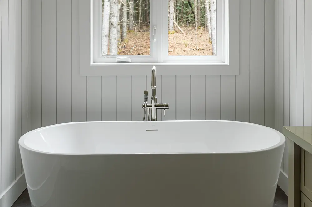 Freestanding soaker tub under a window at Dwight Beach Road
